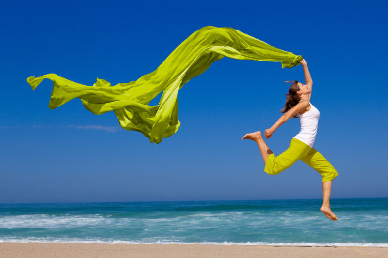 Young woman having fun on the beach